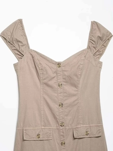 Detailed close-up of khaki midi dress with v-neckline, puff sleeves, and marble buttons