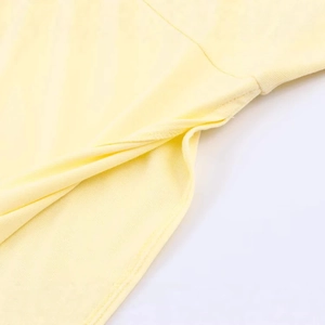 Pale yellow high neck knit top with asymmetric sleeves and fine texture detail