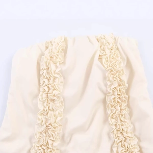 Elegant beige midi dress with symmetrical tiered ruffle details and textured woven fabric