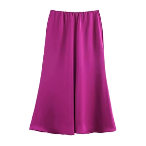 Detailed view of magenta satin midi skirt featuring glossy texture and soft draping fabric
