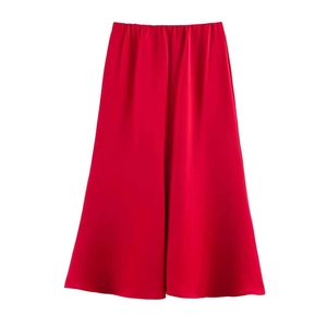 Detail of red satin A-line skirt showcasing the smooth silk texture and lustrous finish