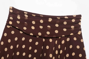 Close-up of pleated waist and polka dot print on coffee brown chiffon skirt