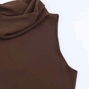 Detail of elegant chocolate brown turtleneck sleeveless top with draped neckline pleats