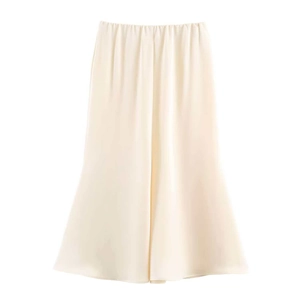 Detailed view of cream satin midi skirt with elastic waist and glossy fabric texture