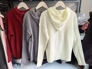 Detail of cable knit texture on hooded sweaters in burgundy, grey, and cream white colors