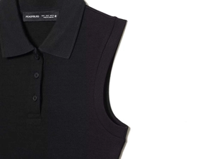 Detail of the knit ribbed texture and classic polo collar on a black sleeveless dress
