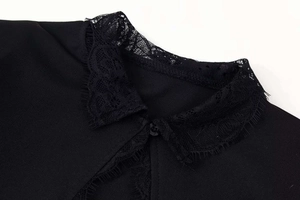 Detail of black lace Peter Pan collar with button and eyelash trim on summer dress