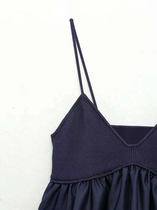 Close-up of navy blue V-neck knit camisole with ribbed texture and pleated stitching details