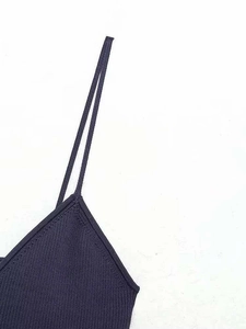 Close-up of navy blue rib-knit tank top featuring slim straps and a fine V-neck texture