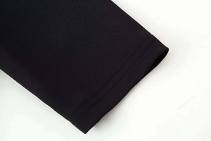 Detailed close-up showing precise double-needle stitching on black summer dress sleeve