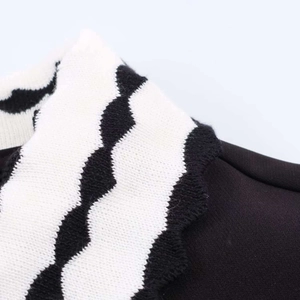Macro shot of striped polo collar with scalloped edges on black women's top