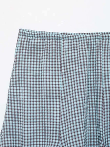 Detailed close-up of elastic waistband on blue plaid seersucker checkered shorts