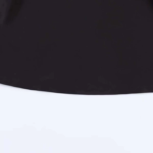 Close-up of the black textile fabric hem showing fine plain weave texture and stitching