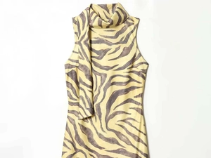 Detail of elegant sleeveless zebra print dress with chic scarf neck tie design