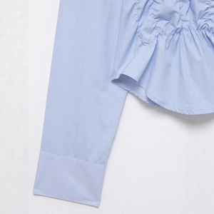 Women's light blue pleated poplin shirt featuring stylish elastic ruffled cuffs and sleeves