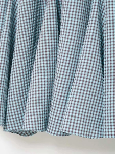 Detailed macro shot of light blue seersucker fabric with irregular checkered pattern
