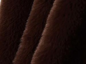Close-up of thick dark brown faux fur fabric with glossy texture and soft high-density pile