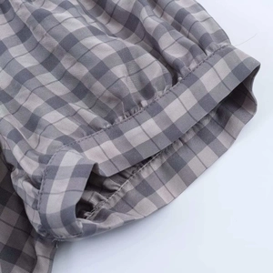 Detail of elastic cuff and grey gingham checkered fabric texture on summer dress