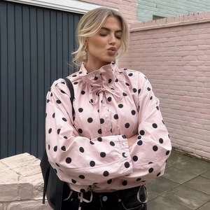 Pink long sleeve blouse with black polka dots, ruffle high neck and tie detail design