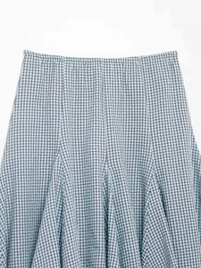 Detailed macro view of the blue and brown plaid fabric texture on a summer skirt
