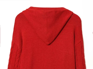 Detailed view of the red cable-knit texture and hood on this thick autumn sweater