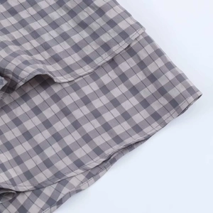 Detailed macro view of gray and white checkered fabric with layered ruffle design
