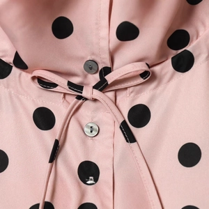 Pink long-sleeve lapel jacket with black polka dots featuring a waist tie bow detail
