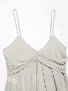 Close-up of ruched V-neckline detail on light grey camisole with adjustable straps