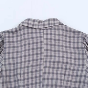 Detail of grey and white checkered dress showing collar stitching and woven texture