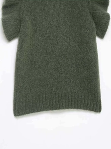 Detail of dark green mohair knit top with layered ruffle sleeves and ribbed hem texture