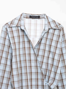 Detail of blue and brown plaid wrap shirt showing collar and INDEFEIR brand label