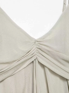 Detail of V-neckline and gathered pleats on this light green crepe camisole top