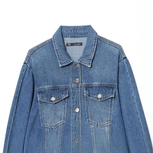 Classic loose-fit washed blue denim jacket with flap pockets and button-down front design