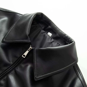 Detailed close-up of collar and silver metal zipper on matte black leather jacket