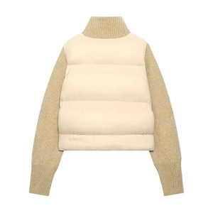 Detail of winter puffer jacket with cream quilted body and oatmeal knitted high collar