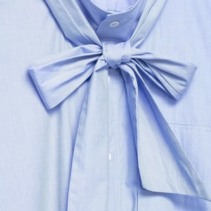 Light blue striped cotton blouse for women with elegant oversized bow and white buttons