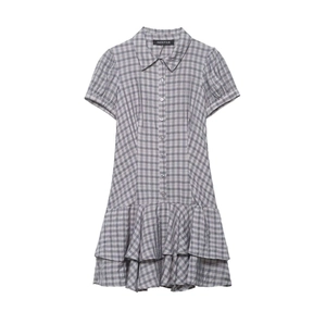 Detail of grey and white plaid shirt dress featuring buttoned front and tiered ruffle hem