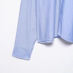 Light blue long sleeve shirt featuring fine fabric texture and detailed hem stitching