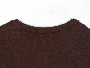 Detail of dark brown knit cardigan with sky blue contrast collar and ribbed texture
