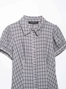 Detail of grey plaid shirt showing standard lapel collar and Indefeir brand label