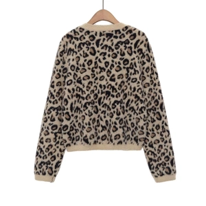 Back view of thick leopard print plush sweater with ribbed cuffs on wooden hanger