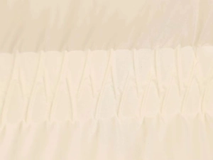 Detail of cream knitted smocking texture on a winter puffer jacket for women
