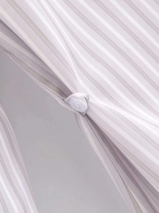 Close-up of gray and white striped fabric texture featuring white round button closure