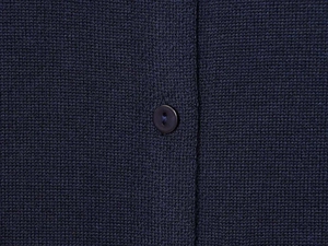 Detailed close-up of dark blue knitted fabric texture with a matching round button
