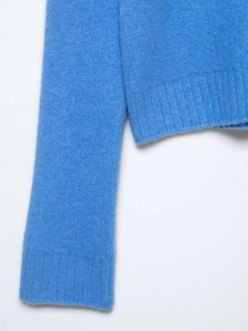 Close-up of the ribbed knit cuffs and soft texture on a light blue zipper sweater