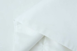 Detailed macro view of white woven fabric texture and seamless invisible zipper closure