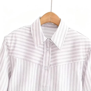 Women's light purple striped shirt featuring a v-shaped patchwork pattern on white background