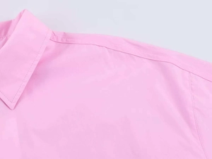 Detail of pink poplin shirt collar and stitching on the shoulder area of the blouse