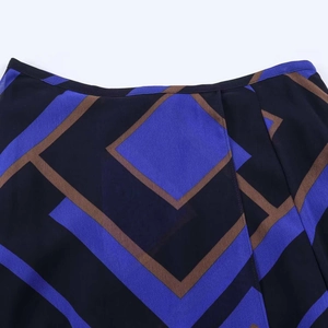 Detail view of vintage geometric print fabric on midi skirt featuring blue and brown pattern