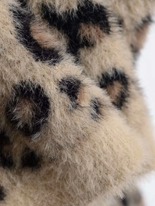 Close-up of leopard print knit sweater showing soft fuzzy mohair texture and detail